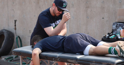 Sports physiotherapist providing hands-on treatment to an athlete during on-site sports physiotherapy in Niagara-on-the-Lake, supporting injury recovery, performance, and return to sport.